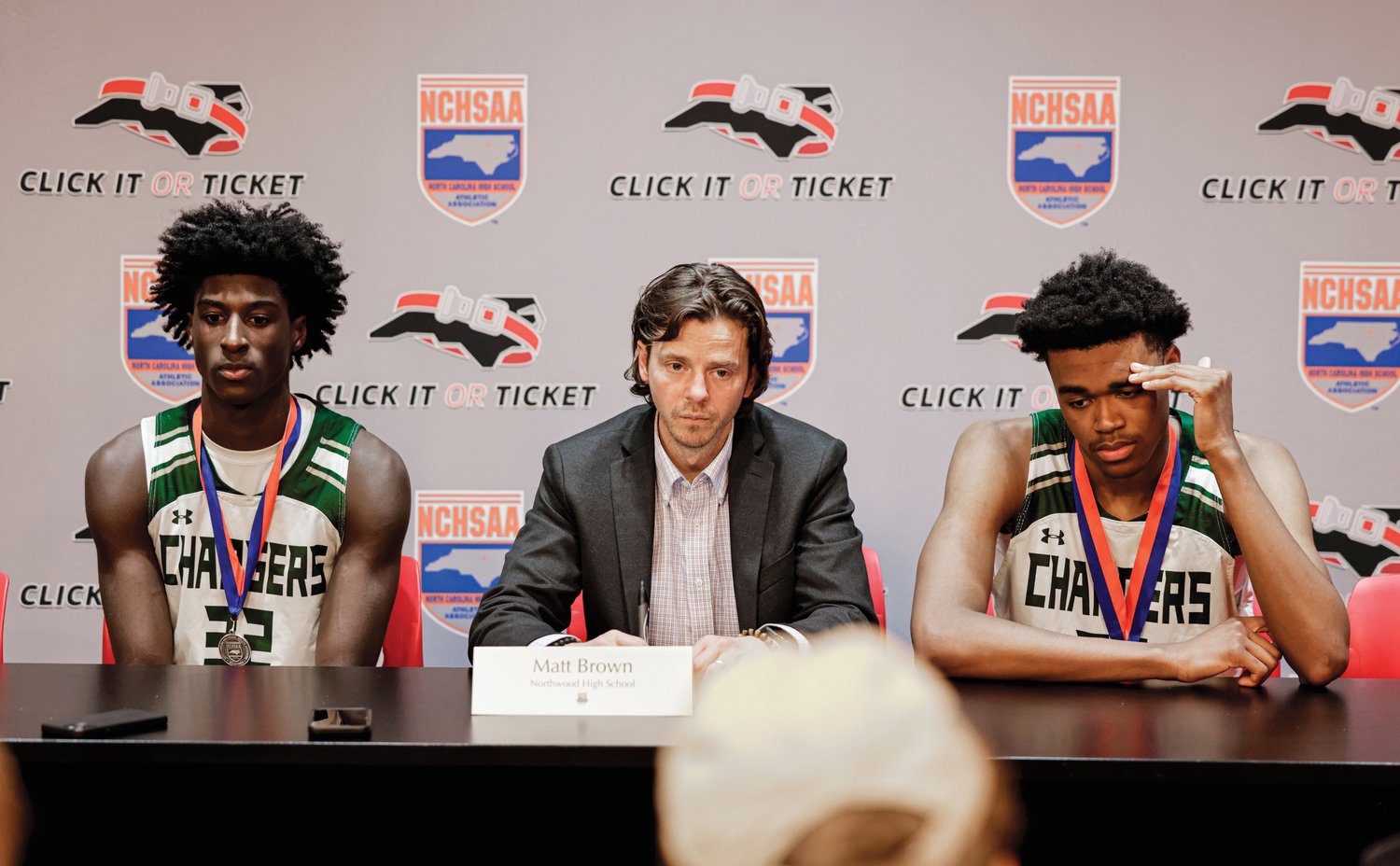 Northwood head coach Matt Brown (center) and players Drake Powell (left) and Max Frazier speak with the media following Saturday's 3A boys final.